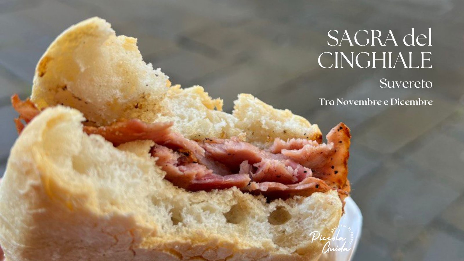 Panino con prosciutto alla Sagra del Cinghiale a Suvereto, evento gastronomico in Val di Cornia.