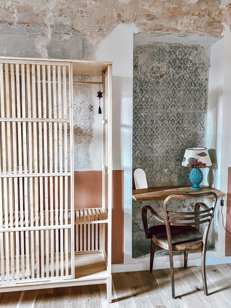 Interno rustico di casa vacanze a Suvereto con scrivania in legno e sedia vintage, atmosfera accogliente.